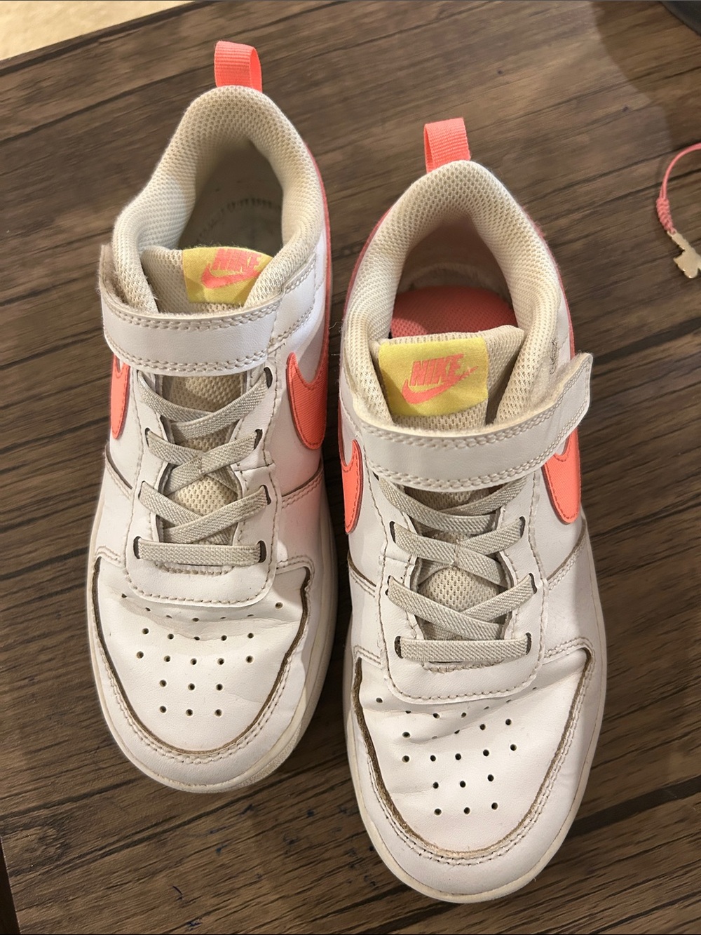 Nike Kids White Sneakers with Coral Swoosh and Yellow Tongue